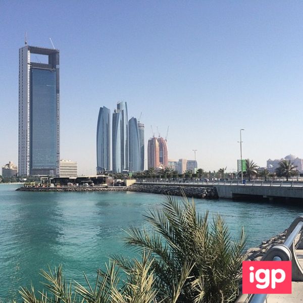 Corniche Beach with blue water and palm trees